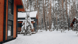 A cozy wooden cabin surrounded by a snowy mountain forest near vacation rentals Brian Head